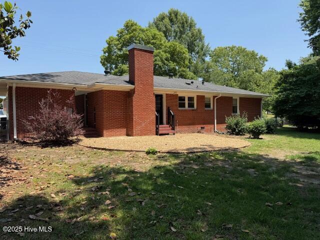 780 Leslie Campbell Ave, Lillington, NC 27546 - back of property featuring entry steps, a chimney, a yard, and brick siding