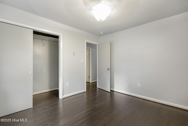 780 Leslie Campbell Ave, Lillington, NC 27546 - unfurnished bedroom with dark wood-style floors, baseboards, and a closet