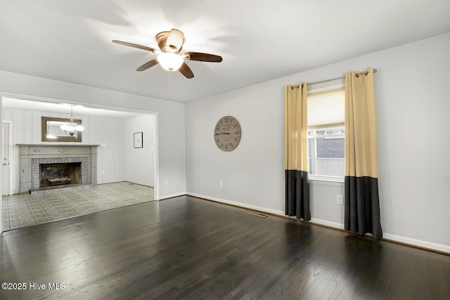 780 Leslie Campbell Ave, Lillington, NC 27546 - unfurnished living room featuring wood finished floors, a ceiling fan, baseboards, and a fireplace