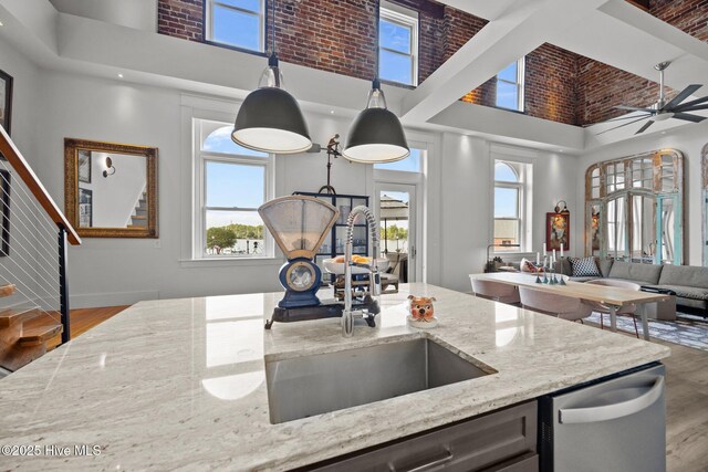183 W Main St Unit 205, Washington, NC 27889 - kitchen featuring a towering ceiling, stainless steel dishwasher, open floor plan, wood finished floors, and plenty of natural light