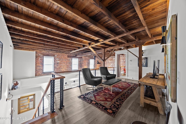 183 W Main St Unit 205, Washington, NC 27889 - sitting room featuring a wooden ceiling with exposed beams, brick wall, wood finished floors, and an upstairs landing