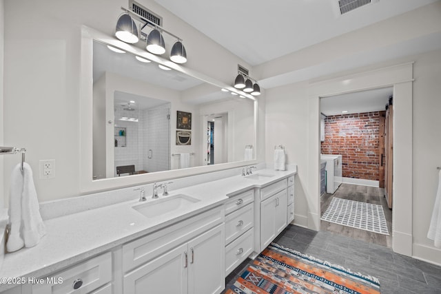 183 W Main St Unit 205, Washington, NC 27889 - full bath featuring double vanity, a shower stall, brick wall, and wood finished floors