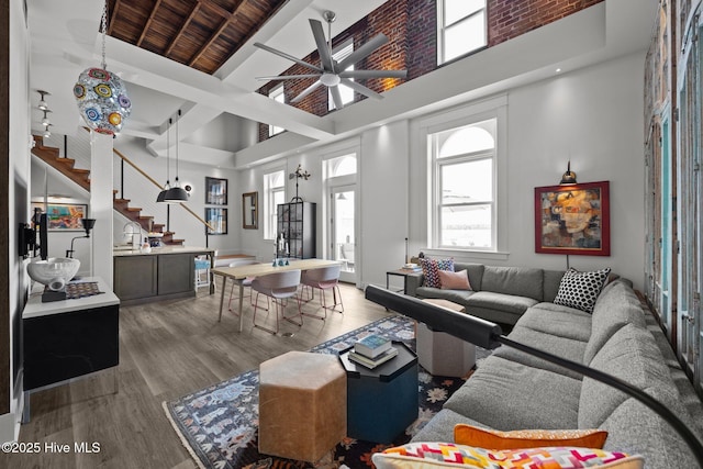 183 W Main St Unit 205, Washington, NC 27889 - living area with a towering ceiling, stairs, wood finished floors, ceiling fan, and beamed ceiling