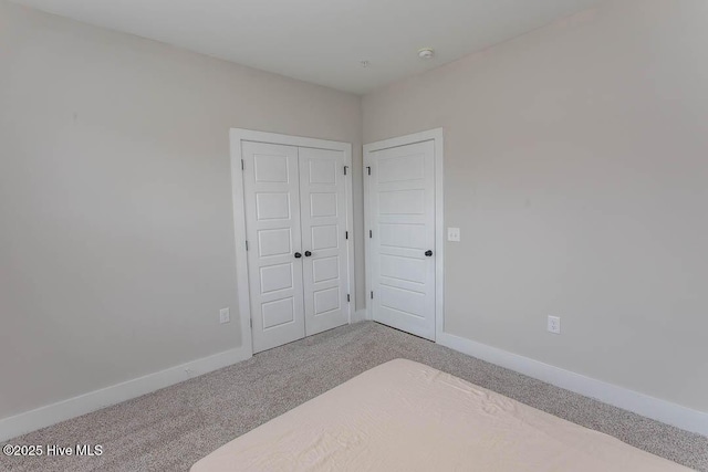 395 S Crow Creek Dr NW Unit 1615, Calabash, NC 28467 - unfurnished bedroom with carpet, baseboards, and a closet