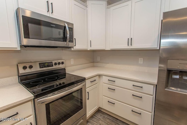 395 S Crow Creek Dr NW Unit 1615, Calabash, NC 28467 - kitchen with appliances with stainless steel finishes, white cabinetry, light stone countertops, and wood finished floors