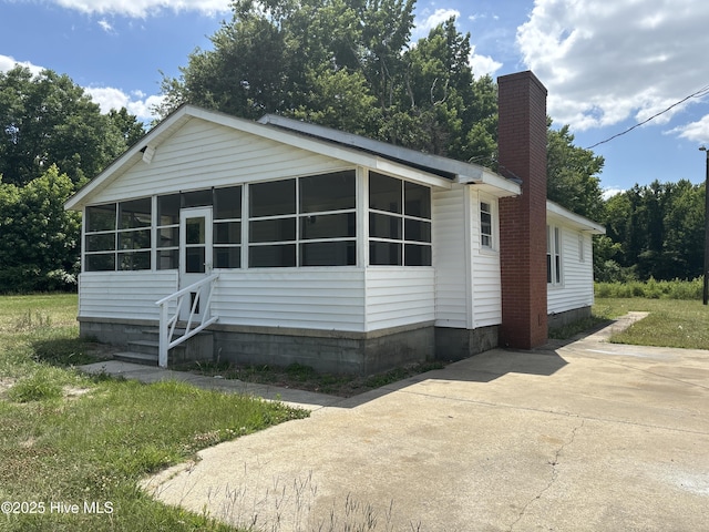 119 Alert Cable Rd, Dudley, NC 28333 - view of front of home featuring a sunroom and a chimney