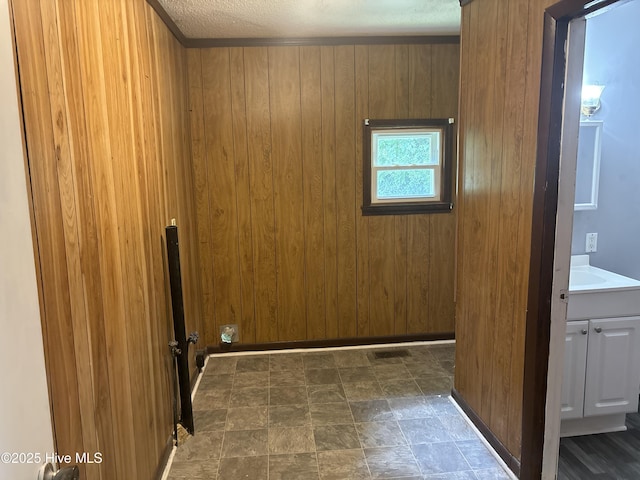 119 Alert Cable Rd, Dudley, NC 28333 - laundry room with wood walls, dark stone finish floors, and cabinet space