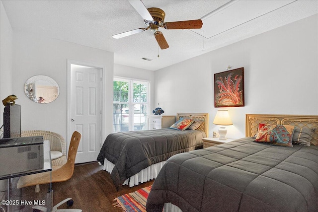 354 Sea Trail Dr E Unit 2, Sunset Beach, NC 28468 - bedroom featuring attic access, wood finished floors, a ceiling fan, and a textured ceiling