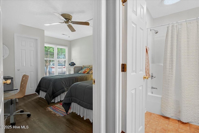 354 Sea Trail Dr E Unit 2, Sunset Beach, NC 28468 - bedroom with wood finished floors, a ceiling fan, and a textured ceiling