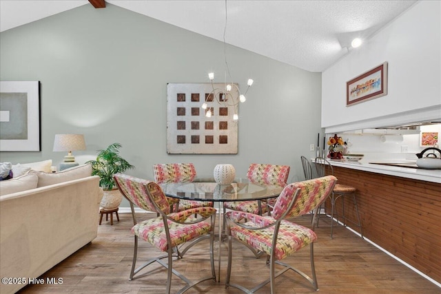 354 Sea Trail Dr E Unit 2, Sunset Beach, NC 28468 - dining space featuring vaulted ceiling, wood finished floors, baseboards, and a chandelier