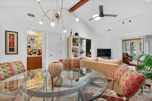 354 Sea Trail Dr E Unit 2, Sunset Beach, NC 28468 - dining space featuring beam ceiling, ceiling fan, high vaulted ceiling, track lighting, and a chandelier
