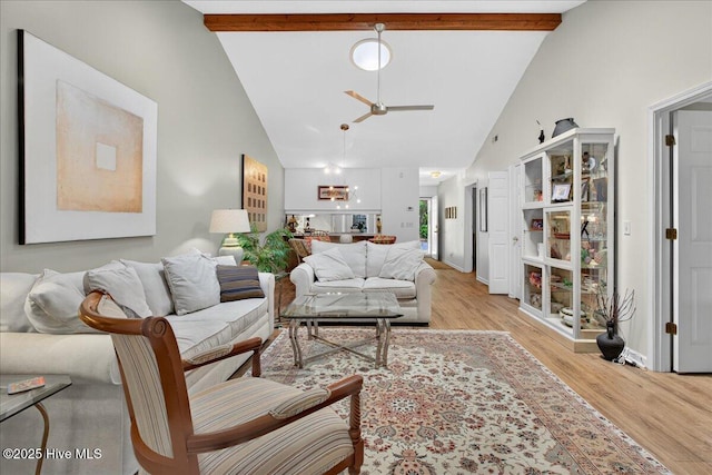 354 Sea Trail Dr E Unit 2, Sunset Beach, NC 28468 - living room featuring a ceiling fan, beam ceiling, light wood finished floors, high vaulted ceiling, and baseboards