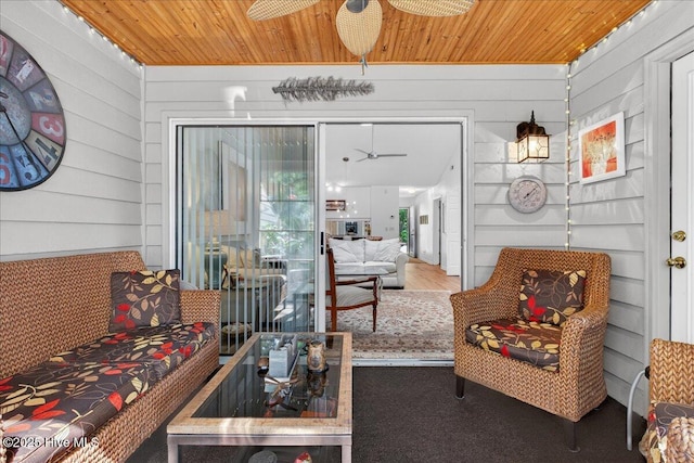 354 Sea Trail Dr E Unit 2, Sunset Beach, NC 28468 - living room featuring ceiling fan, wood ceiling, and wooden walls