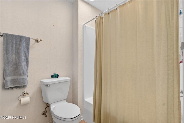 354 Sea Trail Dr E Unit 2, Sunset Beach, NC 28468 - bathroom featuring toilet and shower / bath combo with shower curtain