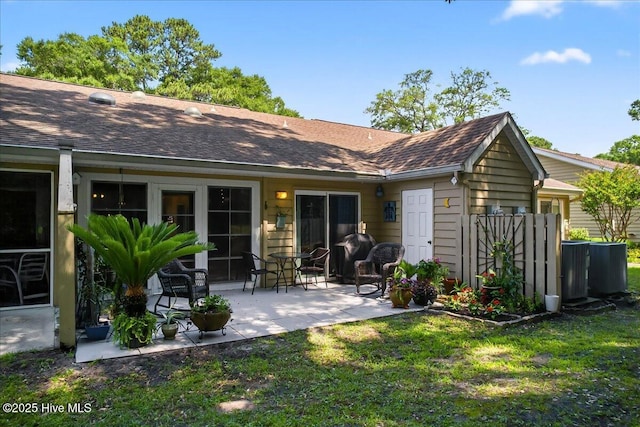 354 Sea Trail Dr E Unit 2, Sunset Beach, NC 28468 - back of property with a yard, a patio, and a shingled roof