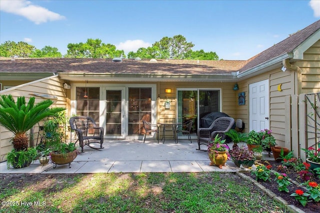 354 Sea Trail Dr E Unit 2, Sunset Beach, NC 28468 - view of exterior entry featuring a patio area and a shingled roof