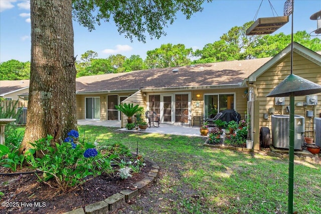 354 Sea Trail Dr E Unit 2, Sunset Beach, NC 28468 - rear view of property featuring central air condition unit, a patio area, and a lawn