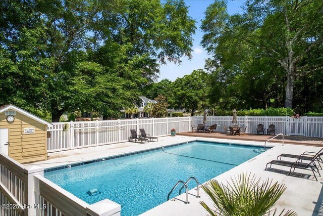 354 Sea Trail Dr E Unit 2, Sunset Beach, NC 28468 - view of swimming pool with a patio and view of wooded area