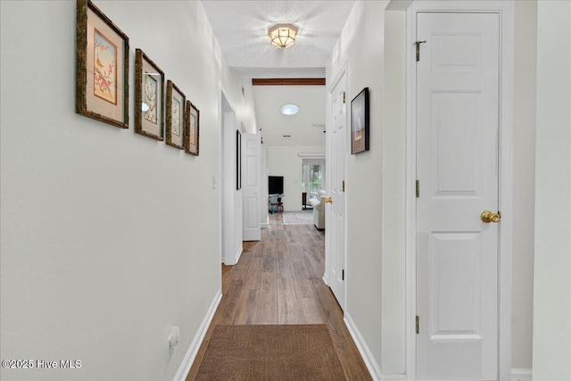354 Sea Trail Dr E Unit 2, Sunset Beach, NC 28468 - hallway with wood finished floors, baseboards, and a textured ceiling
