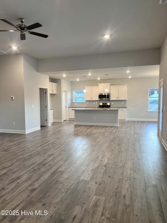 5046 Holly Hill Ct Lot 23, Battleboro, NC 27809 - unfurnished living room with dark wood-style flooring, recessed lighting, baseboards, a ceiling fan, and healthy amount of natural light