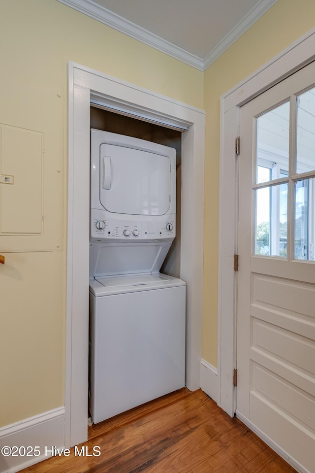528 E 6th St, Washington, NC 27889 - laundry room with stacked washer and clothes dryer, ornamental molding, and wood finished floors