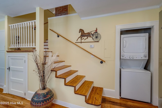 528 E 6th St, Washington, NC 27889 - stairway featuring stacked washer / dryer, crown molding, and wood finished floors