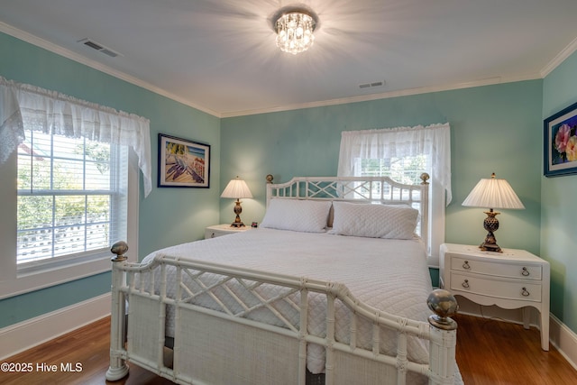 528 E 6th St, Washington, NC 27889 - bedroom with wood finished floors, ornamental molding, and a chandelier