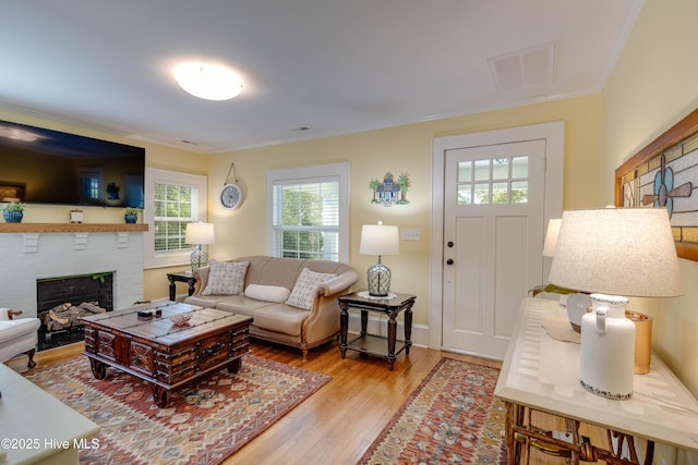 528 E 6th St, Washington, NC 27889 - living area with wood finished floors, ornamental molding, and a brick fireplace
