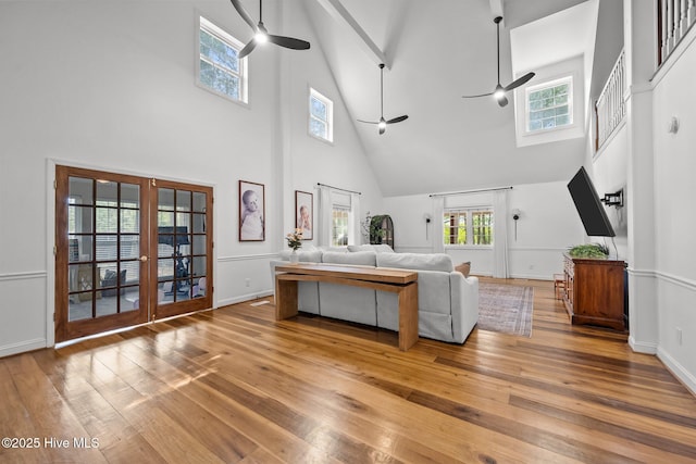 4967 E NC-24 Hwy, Beulaville, NC 28518 - living room featuring a high ceiling, ceiling fan, french doors, wood-type flooring, and plenty of natural light