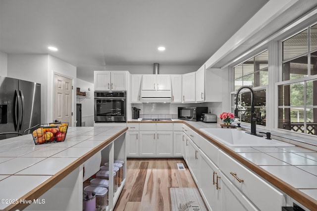 4967 E NC-24 Hwy, Beulaville, NC 28518 - kitchen featuring black appliances, tile counters, a sink, white cabinetry, and recessed lighting
