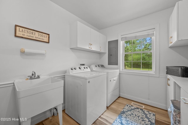 4967 E NC-24 Hwy, Beulaville, NC 28518 - laundry room with cabinet space, independent washer and dryer, electric panel, and light wood-style flooring