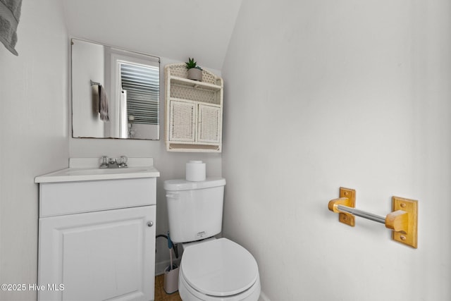4967 E NC-24 Hwy, Beulaville, NC 28518 - bathroom with toilet, vanity, vaulted ceiling, and baseboards