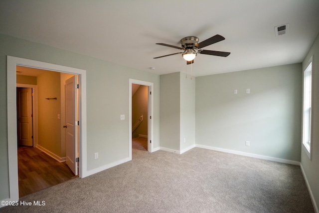332 Starfish Ln, Sneads Ferry, NC 28460 - unfurnished bedroom with carpet, multiple windows, and a ceiling fan