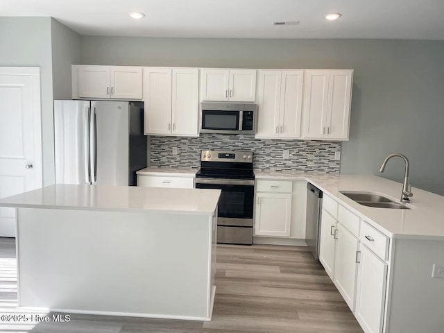 332 Starfish Ln, Sneads Ferry, NC 28460 - kitchen featuring stainless steel appliances, light countertops, light wood-style flooring, white cabinets, and recessed lighting