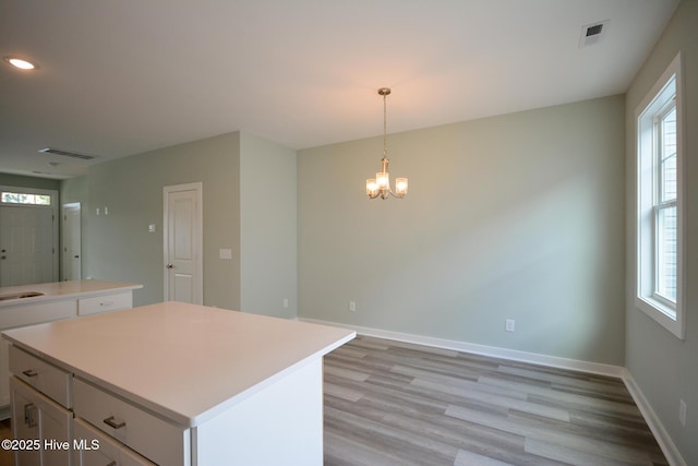 332 Starfish Ln, Sneads Ferry, NC 28460 - kitchen with a kitchen island, healthy amount of natural light, white cabinetry, a chandelier, and recessed lighting