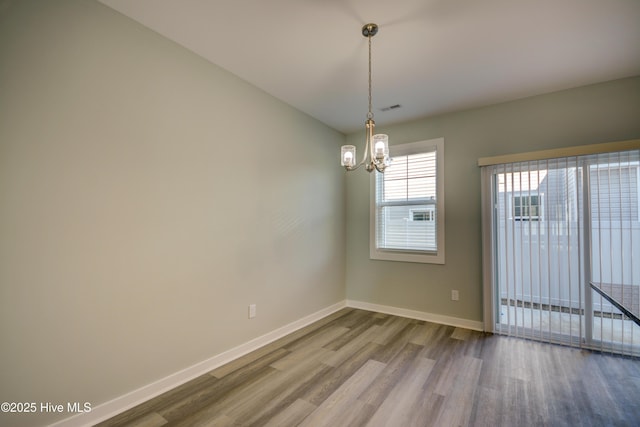 332 Starfish Ln, Sneads Ferry, NC 28460 - spare room with dark wood-style floors, a chandelier, and baseboards