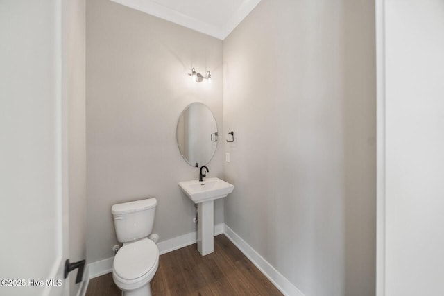 2593 Alvernia Dr, Castle Hayne, NC 28429 - half bathroom with wood finished floors, toilet, and baseboards