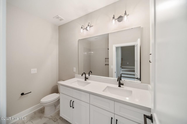 2593 Alvernia Dr, Castle Hayne, NC 28429 - bathroom featuring marble look tile flooring, double vanity, toilet, baseboards, and a shower