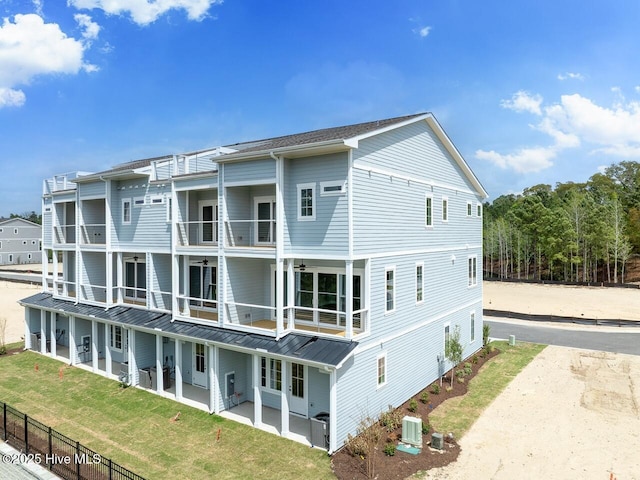 2593 Alvernia Dr, Castle Hayne, NC 28429 - rear view of property featuring a balcony, a patio area, central air condition unit, a standing seam roof, and metal roof