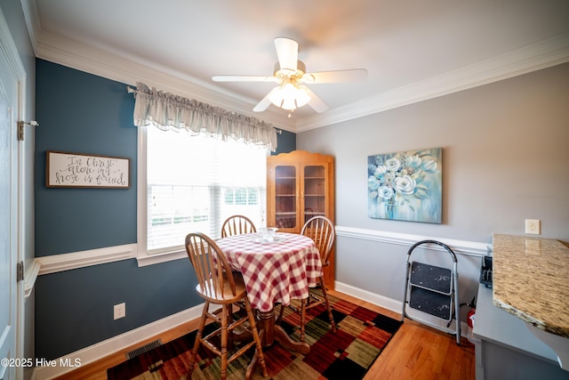 3804 Wyattwood Dr N, Wilson, NC 27896 - dining area featuring ornamental molding, a ceiling fan, wood finished floors, and baseboards