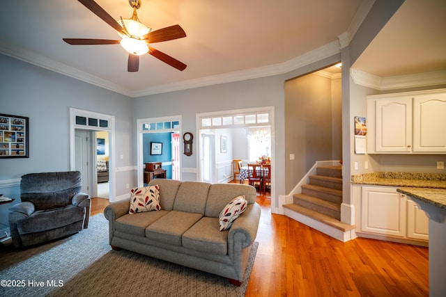 3804 Wyattwood Dr N, Wilson, NC 27896 - living room with ornamental molding, light wood-style flooring, ceiling fan, and stairway