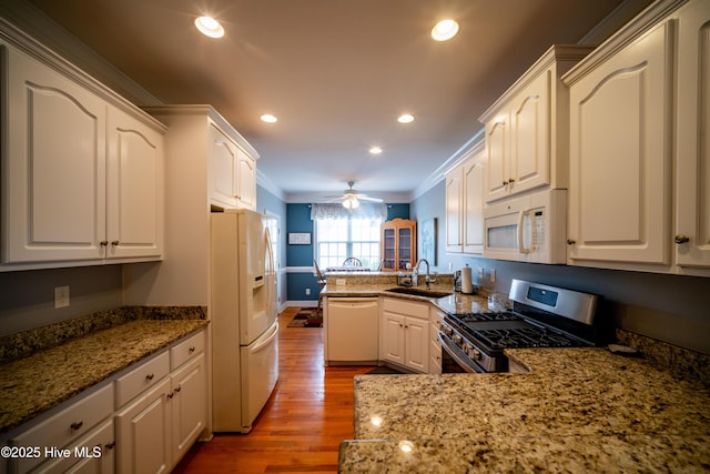 3804 Wyattwood Dr N, Wilson, NC 27896 - kitchen featuring white appliances, a sink, crown molding, a peninsula, and wood finished floors