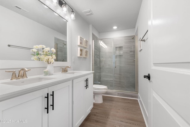 2968 Hatchers Run, Leland, NC 28451 - full bath featuring toilet, double vanity, a stall shower, wood finished floors, and recessed lighting
