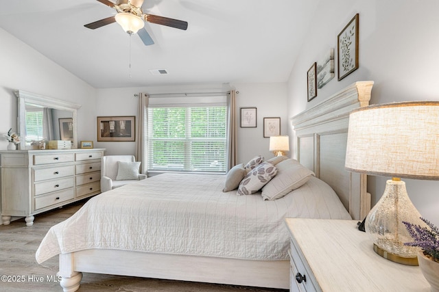 2968 Hatchers Run, Leland, NC 28451 - bedroom with lofted ceiling, multiple windows, wood finished floors, and a ceiling fan