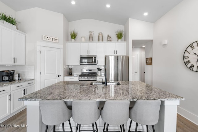 2968 Hatchers Run, Leland, NC 28451 - kitchen with appliances with stainless steel finishes, a sink, tasteful backsplash, wood finished floors, and vaulted ceiling