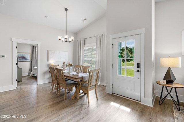 2968 Hatchers Run, Leland, NC 28451 - dining area with a chandelier, light wood-style flooring, baseboards, and high vaulted ceiling