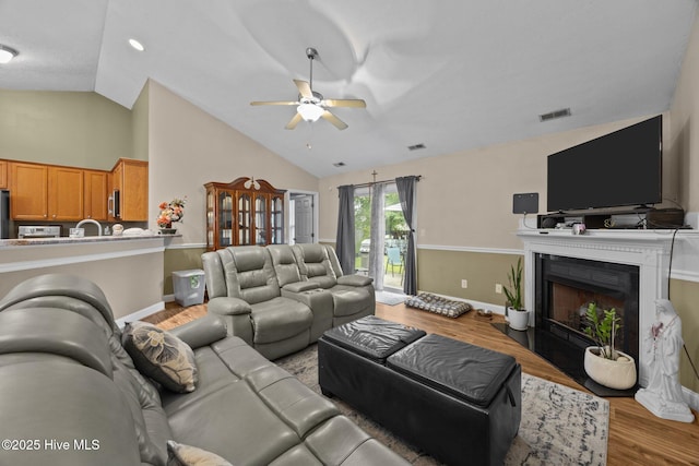 3106 John Willis Rd, New Bern, NC 28562 - living room with ceiling fan, light wood-type flooring, baseboards, a fireplace, and high vaulted ceiling