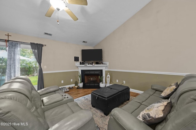 3106 John Willis Rd, New Bern, NC 28562 - living area featuring lofted ceiling, wood finished floors, a ceiling fan, baseboards, and a fireplace