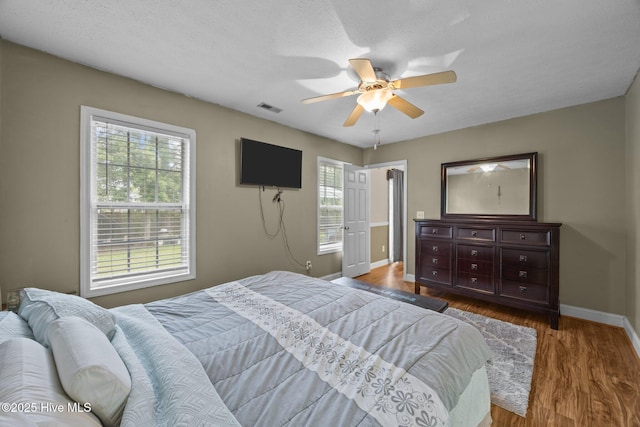3106 John Willis Rd, New Bern, NC 28562 - bedroom featuring baseboards, wood finished floors, and a ceiling fan