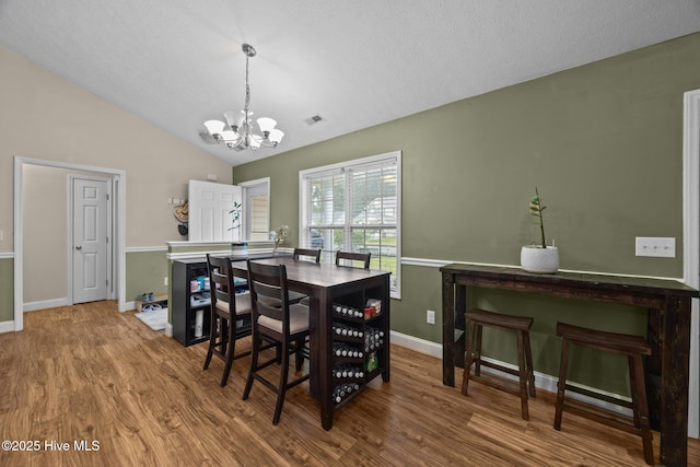 3106 John Willis Rd, New Bern, NC 28562 - dining space featuring a chandelier, wood finished floors, baseboards, and lofted ceiling